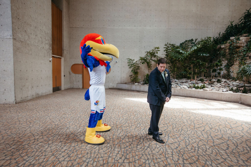 A groom on his wedding day turning around to see his college mascot instead of his bride as a surprise.