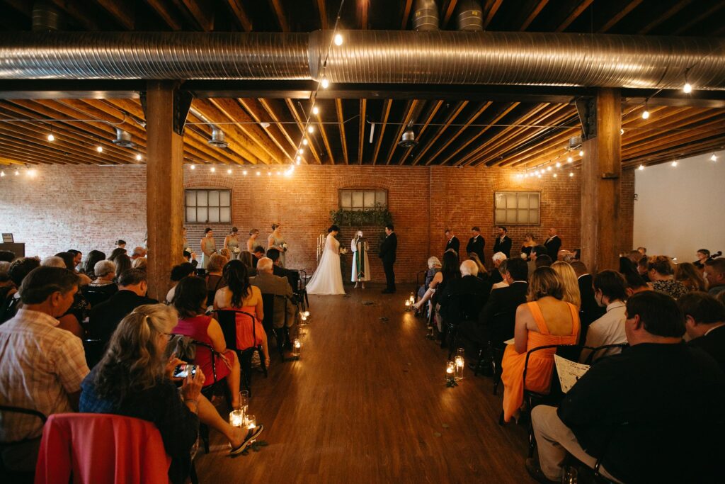 A bride and groom standing at the altar on their wedding day at UNION in Kansas City, Missouri.