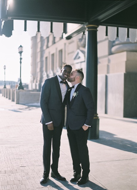 Two grooms share a moment at their Kansas City wedding