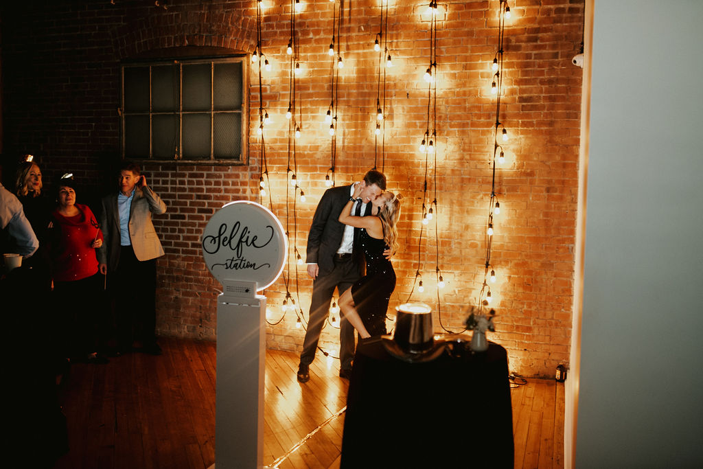 Couple taking a photo at UNION's photo booth