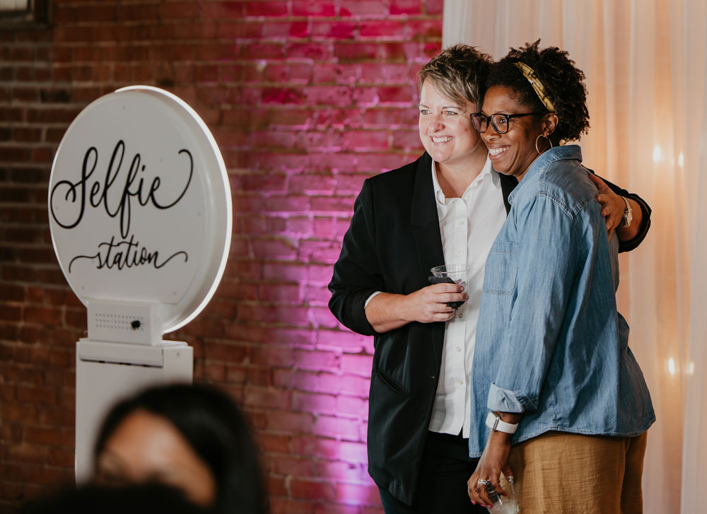 Guests posing in front of a photo booth at UNION