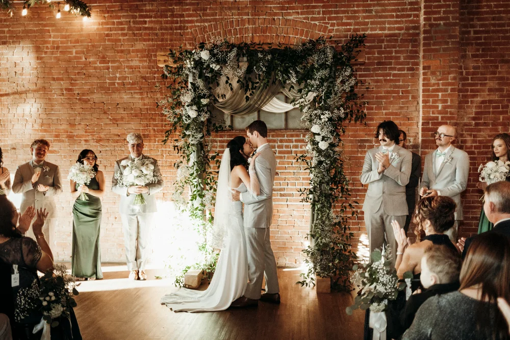 Bride and groom kissing after they say "I do" at UNION