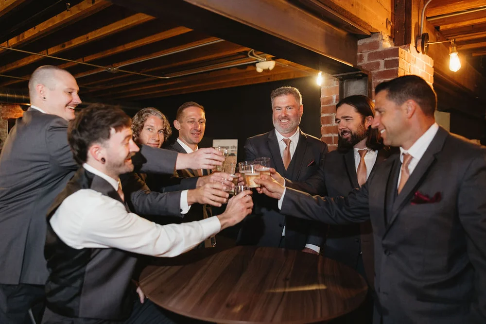 Groom and groomsmen toasting in UNION's Speakeasy in Kansas City, MO