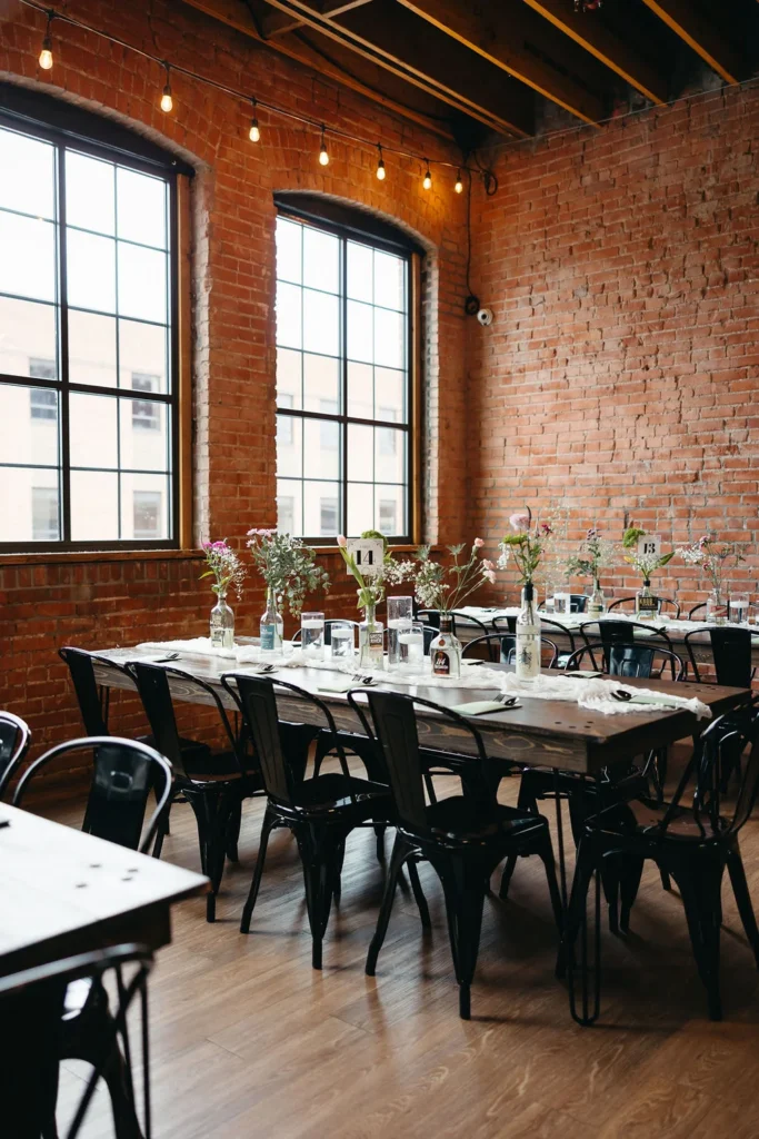 Wedding reception tables set up with simple florals at UNION in Kansas City