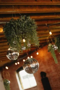Disco balls and greenery hanging from the rafters at UNION in downtown Kansas City.
