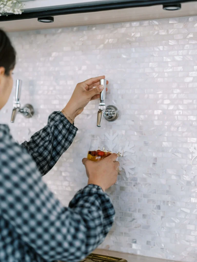 Party guest pouring beer into a glass from a tap at Kansas City holiday party at UNION