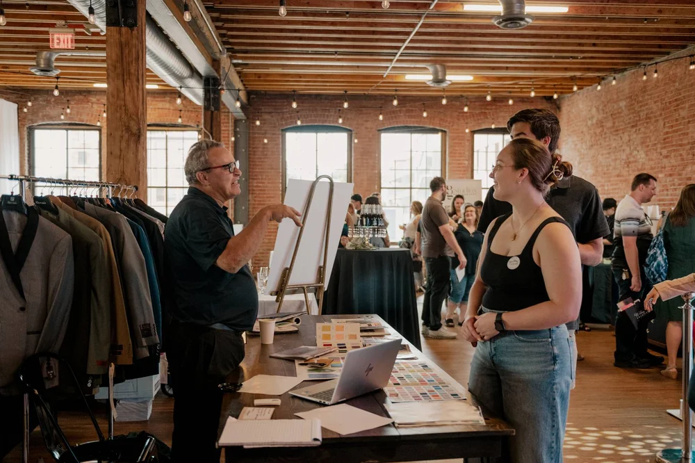 Office Holiday party guests talking to market vendors