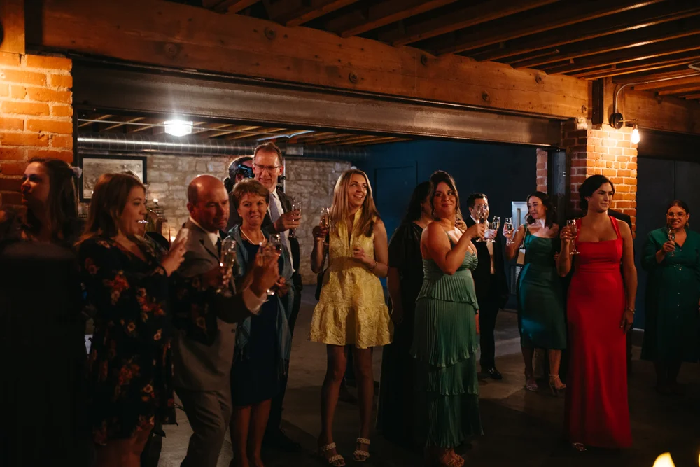 Guests lined up for a toast at an engagement party in The Goldfinch Room at UNION, Kansas City
