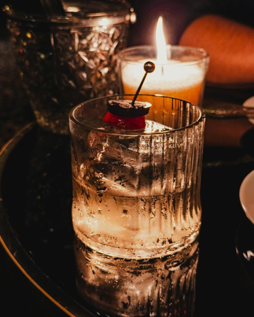 Speakeasy-style cocktail with candlelight ambiance at The Goldfinch Room, UNION Kansas City