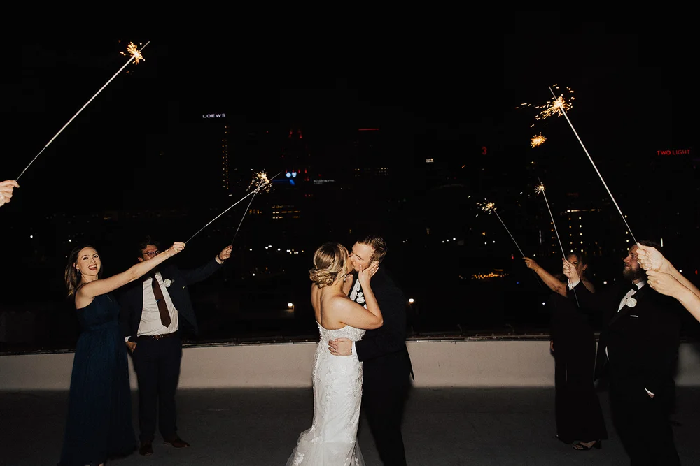 Bride and groom kissing on rooftop at UNION Kansas City wedding