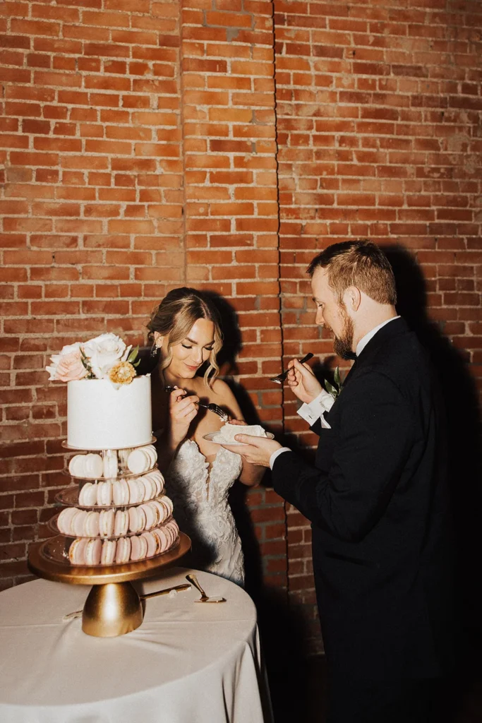 Kansas City couple cutting wedding cake at intimate fall wedding at UNION