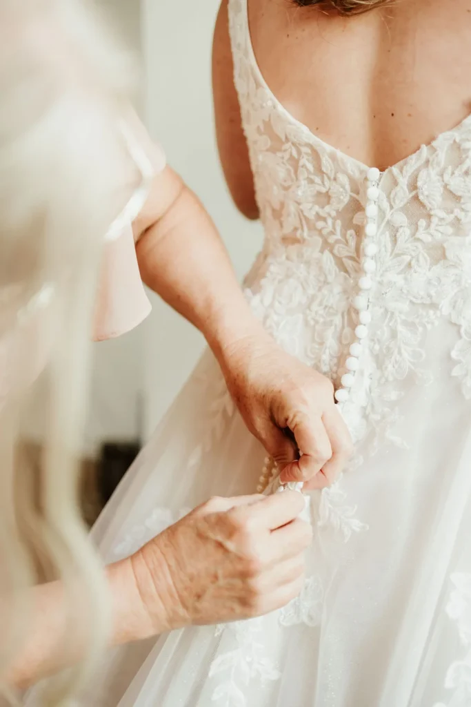 Bride getting ready with mom’s help at Kansas City wedding