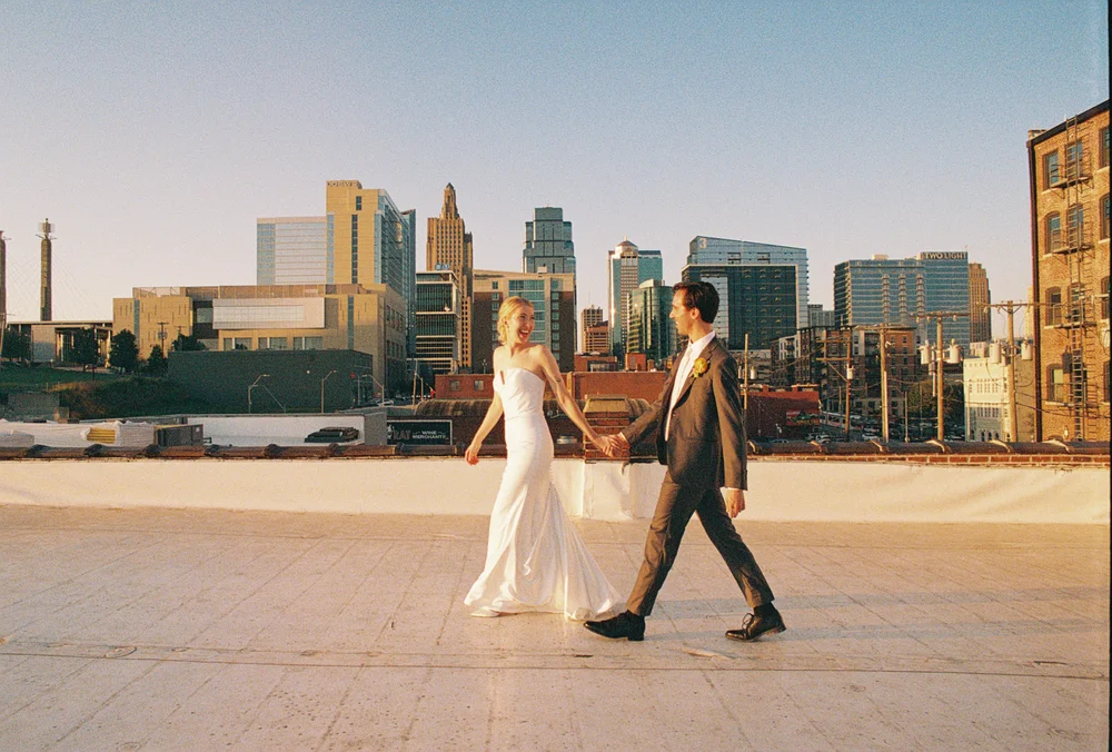 Bride and groom walking across UNION's rooftop in Kansas City