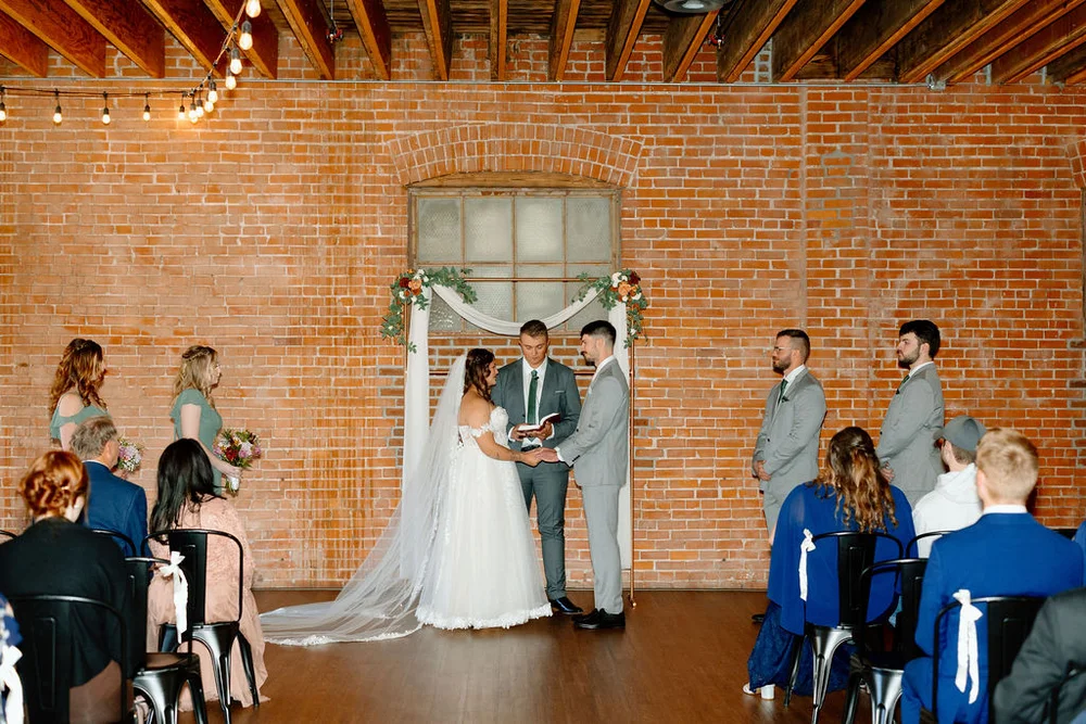 Bride and groom at the altar during their modern rustic wedding ceremony at UNION in Kansas City MO